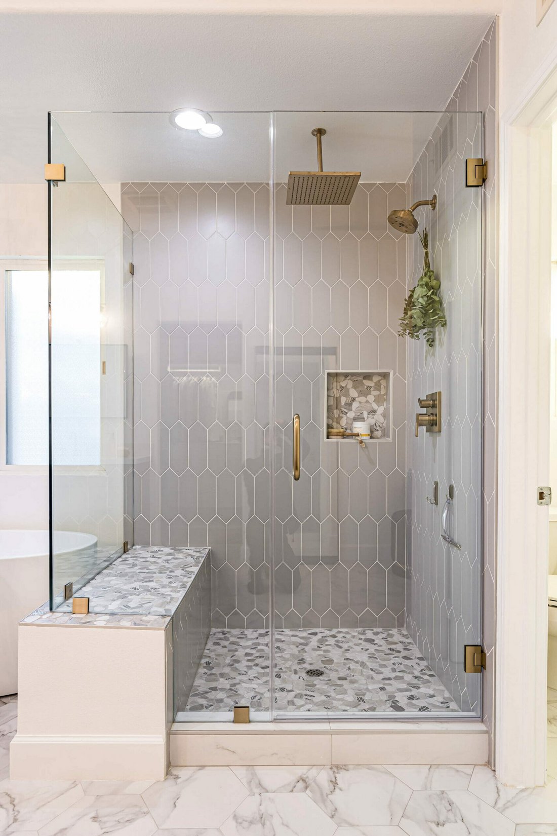 Spa bathroom with glass walk-in shower and brass fixtures
