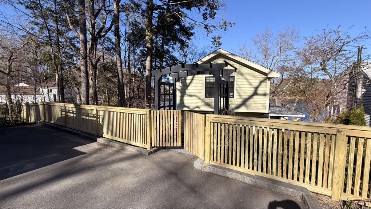 Finished cedar fence and gate enclosing the driveway