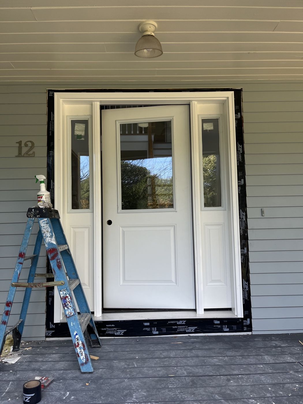 New white entry door with sidelights installed